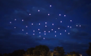 49 quadrocopters with lights roam the night sky in formation
