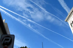 Shiny object flying near contrails over Los Angeles