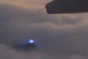 UFO filmed from plane at 30,000 feet over the ocean
